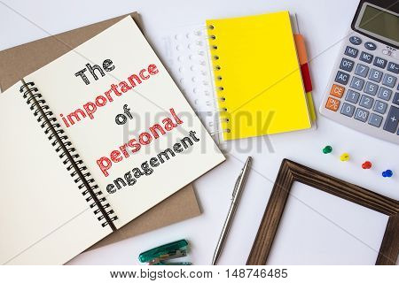 Text The importance of personal engagement on white paper book on table / business concept