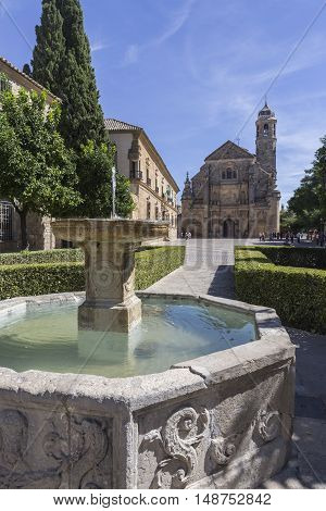 Ubeda Spain - September 18 2016: The Sacred Chapel of El Salvador (Capilla del Salvador) in the Plaza de Vazquez de Molina with the Parador hotel to the left Ubeda Jaen Province Andalusia Spain Western Europe