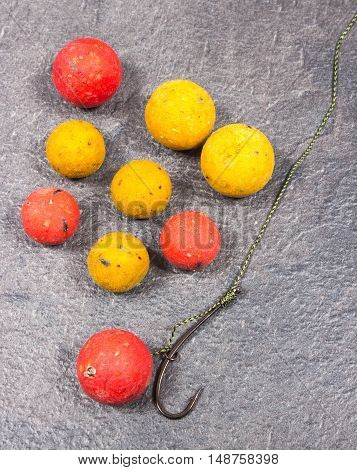 Carp Hook Boilies on black background .