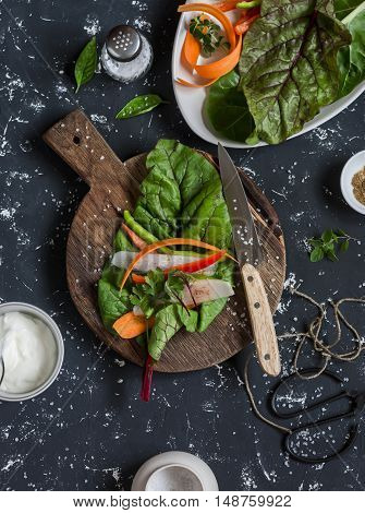 Ingredients to prepare vegetable rolls on dark background top view. Vegetarian snack