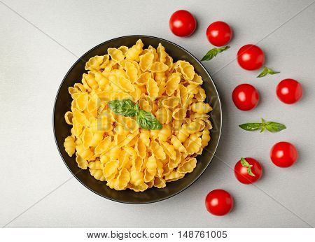 Plate with gnocchi pasta and tomatoes on table