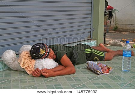 Pattaya Thailand - March 21 2015: homeless man is sleeping outdoor in Pattaya Thailand