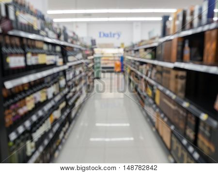Blurred alcoholic drinks on shelf in the supermarket