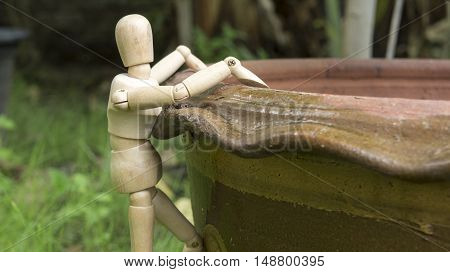 wooden human figure climb tree pot garden