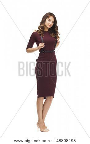 Portrait in full growth the young beautiful woman in a vinous knitted dress, isolated on white background