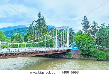 The bridge of Beauty over the Kura river leads to the Historic Mineral Water Park the central object in spa resort of Borjomi Georgia.