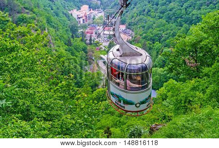 BORJOMI GEORGIA - MAY 27 2016: The aerial tram rides down from the upper Plateau Station to the mineral water park located in green gorge on May 27 in Borjomi.