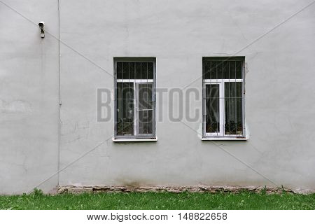 gray wall with two windows and gtass line