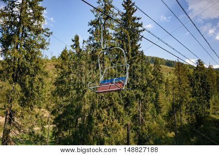 Lift in the Carpathians with green spruce trees in Summer