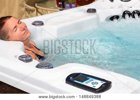 Beautiful woman relaxing in hot tub.