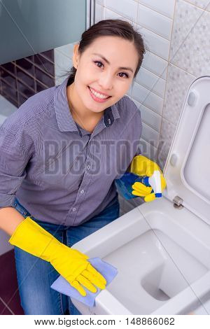 Young beautiful asian woman housekeeping in the bathroom