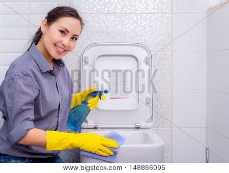 Young beautiful asian woman housekeeping in the bathroom