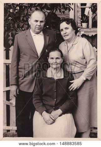 VITEBSK BELARUS - CIRCA 1965: Family portrait of elderly woman and her brother with his wife (vintage photo 1965)