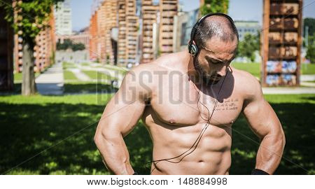 Handsome Muscular Shirtless Hunk Man Outdoor in City Setting. Showing Healthy Body While Looking away