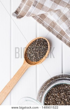 Chia seeds in wooden spoon. Top view. Healthy superfood.