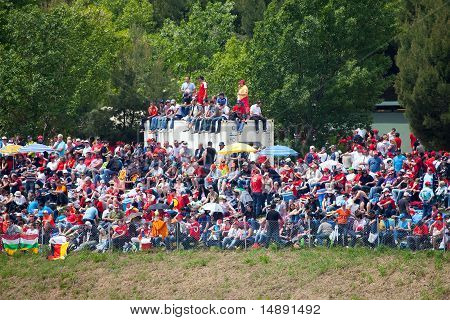 Spectators on grass on The Formula 1 Grand Prix