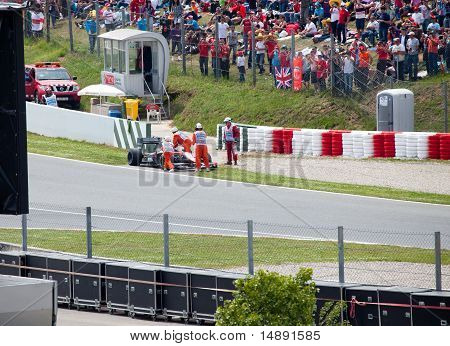 The racing car take off from line in sandy zone during The Formula 1
