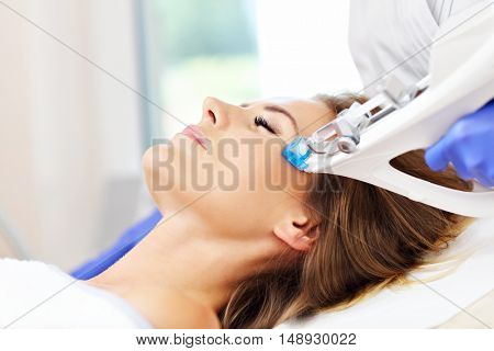 Picture of woman having facial mesotherapy in beauty salon
