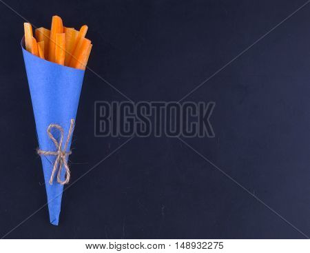 Carrot Sticks In A Blue Lie From Left. Blue Bag Tied With String On Black Background Markovna Sticks