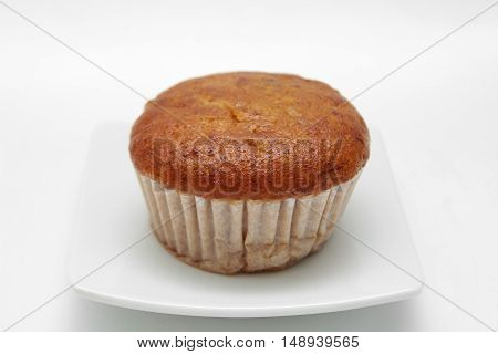 Banana cupcake with chololate on white plate
