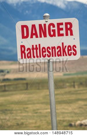 Rattlesnake warning sign in an american countryside