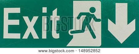 A Green emergency exit sign on white