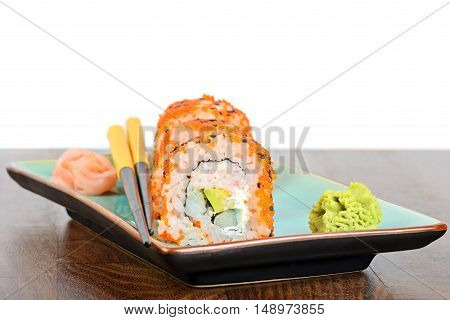 California maki sushi with masago. Made of crab meat, avocado, cucumber and orange masago. Shallow depth of field.