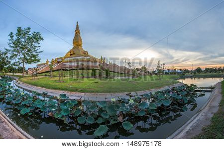 Famous Maha Mongkol Bua Pagoda In Roi-ed Thailand At Sunset.