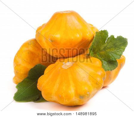 four yellow pattypan squash with leaf isolated on white background.