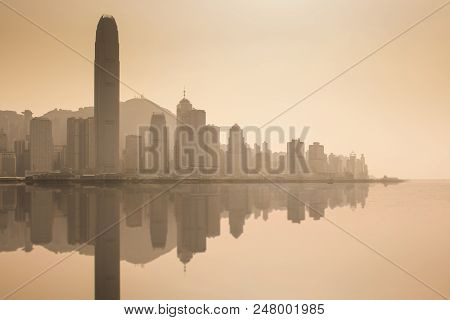 Hong Kong City Skyline Business District At Dusk And Refelction Effect.