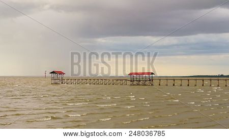 Pier & Hut With Stormy Dark Sunset In Tropical Sea In Sipitang,sabah Borneo,malaysia.