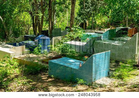 Outdoor Graveyard In The Forest. Scary And Ancient Gravesite In The Mountain.