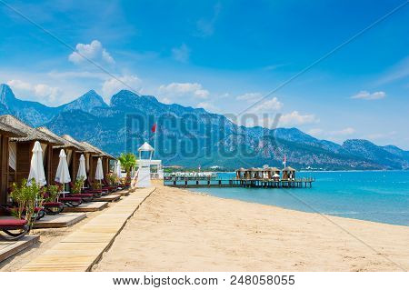 Antalya, Turkey - 9 May 2018: Wooden Beach Pavilions On The Shore Of A Sandy Beach - The Mediterrane