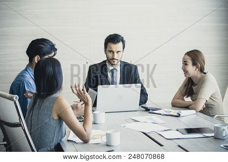 Young Business People Working Together With Serious Emotion. Business People Takling In Modern Offic
