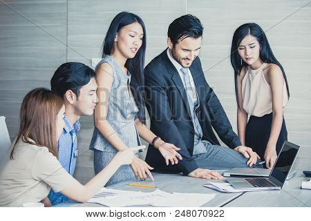 Young Business People Working Together With Happy Emotion. Business People Takling In Modern Office.