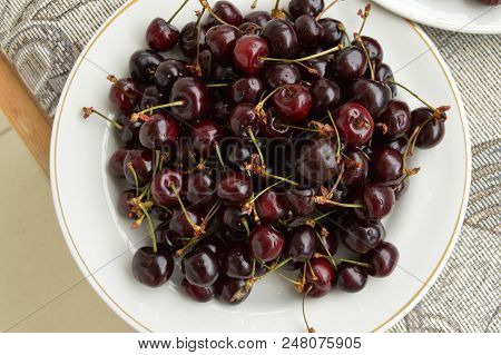 Fresh Ripe Cherry On A Plate, Top View.