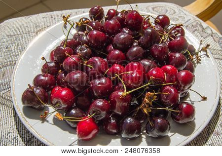 Fresh Ripe Cherry On A Plate, Top View.