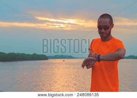 Checking The Time After Exercising / Jogging Outdoors.