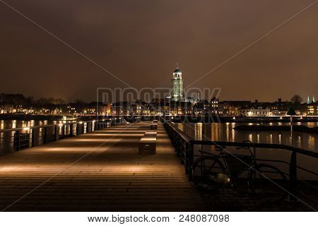 Deventer At Night View From The Other Side Of The Ijssel With The Lebuinuschurch And The New Pier
