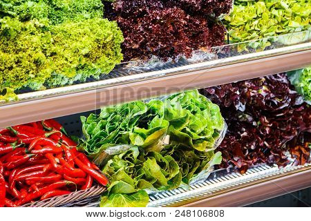 Colourful Mix Of Different Red, Green, Violet Fresh Vegetables And Greens At The Shelfs Of Supermark