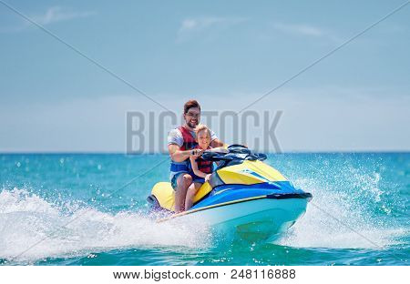 Happy, Excited Family, Father And Son Having Fun On Jet Ski At Summer Vacation