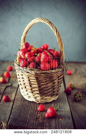 Ripe Sweet Strawberries In Wicker Basket On Lold Wooden Rustic Table. Agriculture Farmer Harvest. Co