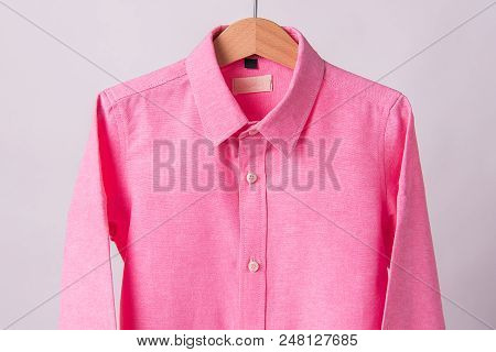 Hanging Pink Shrits On White Background, Hanger.