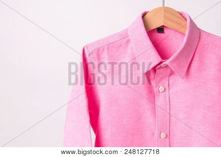 Hanging Pink Shrits On White Background, Hanger.