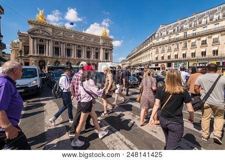 Paris, France - 25 June 2018: A Crowd Of People Crossing Rue De La Paix Near Paris Opera Garnier.