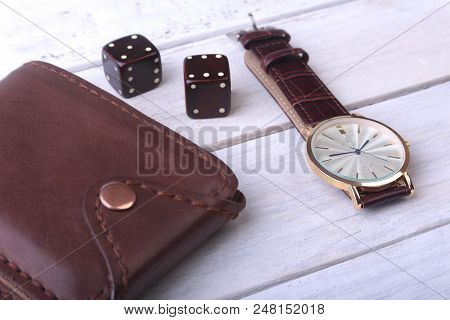 Men's Accessories For Business And Rekreation. Watch, Leather Wallet And Dice On Wood Background.. T