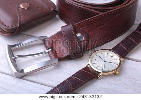 Men's Accessories For Business And Rekreation. Leather Belt, Wallet, Watch And Smoking Pipe On Wood 