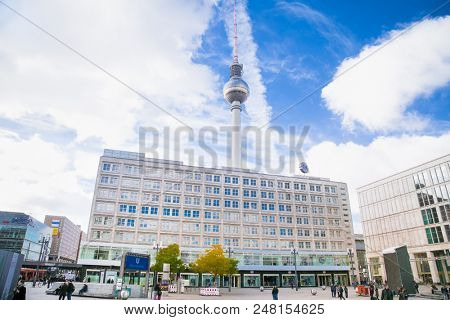 BERLIN GERMANY - OCT 30, 2016: People near fountain on Alexanderplatz square in Berlin city on Oct 30, 2016. Germany. Alexanderplatz is large public square and transport hub in central Mitte district