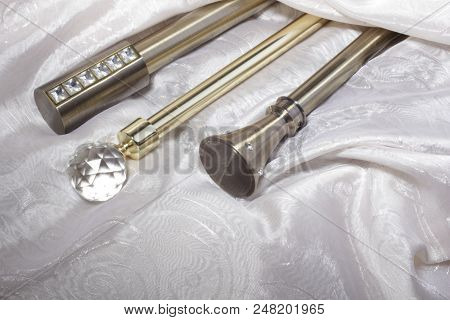 Metal ending for cornices and the folded fabric. Curtain rod and finials on the folded fabric