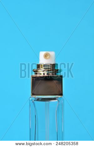 Empty Perfume Bottle On A Blue Background